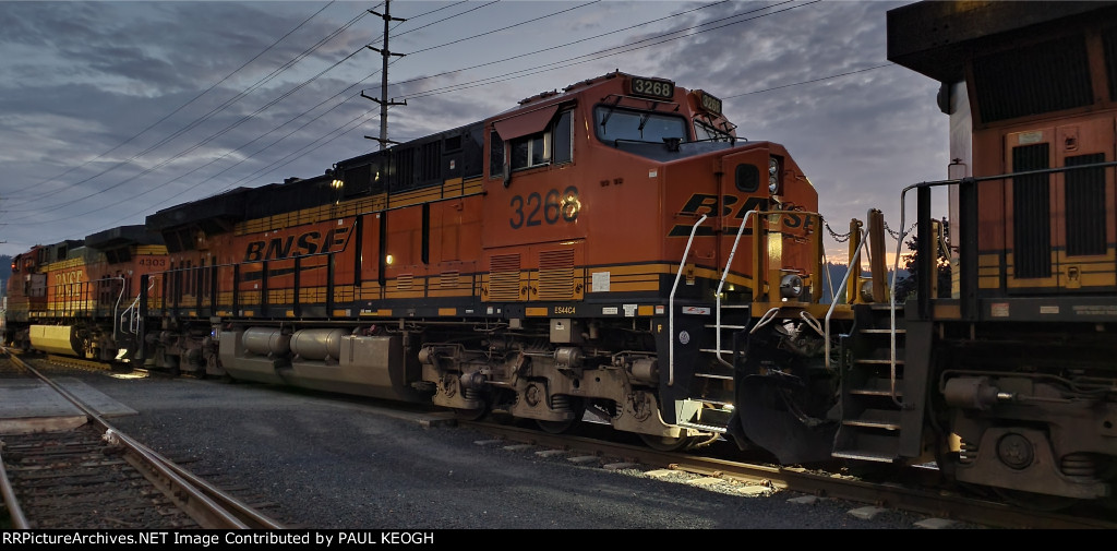 BNSF 3268 waits to detach from the Rear DPU Before reversing into pickup Her Empty Grain Train Cars